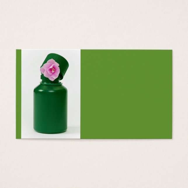 botella verde pequeña y flor rosa (Frente)