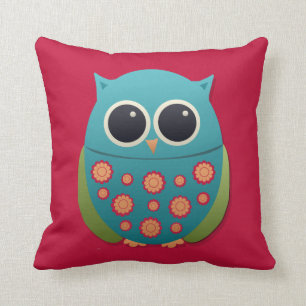 Búho azul y verde lindo sobre almohada roja