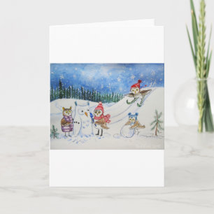 Búhos del navidad que juegan en nieve