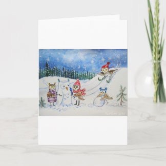 Búhos del navidad que juegan en nieve