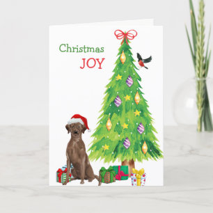 Cachorro de cachorro y árbol de Navidad en el labo