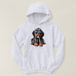 Cachorro de Rottweiler en sudadera encapuchada