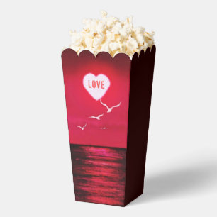 Cajas de palomitas de puesta de sol en el mar