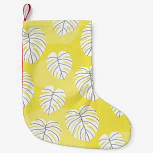 Calcetín Navideño Pequeño Hojas de monstera, fondo amarillo brillante.