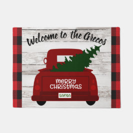 Camión rojo vintage con alfombra de bienvenida de 