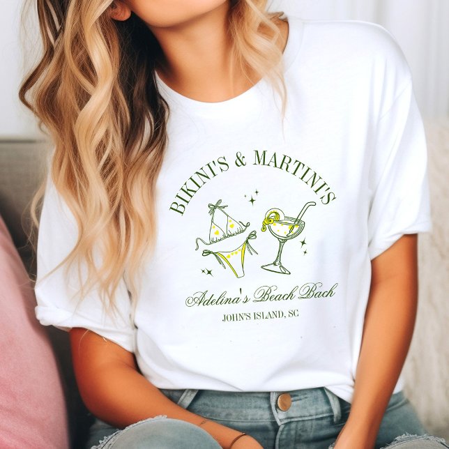 Camiseta Beach Bachelorette Party Favor Social Club (Woman in a casual setting wearing a white T-shirt with a fun design of a bikini and martini glass. )