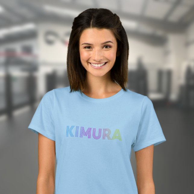 Camiseta BJJ Kimura brasileña Jiu Jitsu Blue Women's (Blue BJJ Kimura T-shirt worn by a female model in the gym.)
