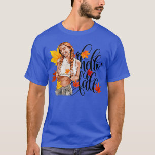 Camiseta Chica de moda de la cabeza roja en hojas de otoño