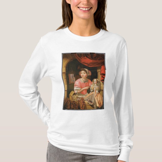 Camiseta Chica que sostiene una muñeca en un interior (Anverso)