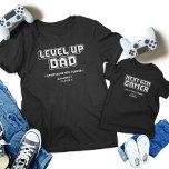 Camiseta Coincidencia de jugador de nivel superior padre hi<br><div class="desc">¡Celebra el último enlace de juego con nuestras camisetas de juego "Gamer Dad & Next Gen Player"! Con diseños retro "Level Up Dad" y "Next Gen Gamer", estos camisetas son perfectos para el Día del Padre, cumpleaños o cualquier evento de juego. Muestra tu pasión compartida con gráficos atrevidos y pixelados....</div>