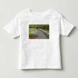Camiseta De Bebé Camino de acera a través de tulipanes y narcisos, 
