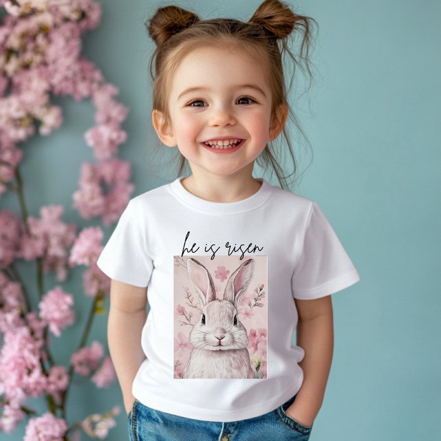 Camiseta De Bebé "Él ha Resucitado" Conejo Rosa con Flor (Subido por el creador)