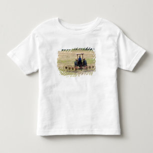 Camiseta De Bebé Un muchacho que conduce un tractor cosechando