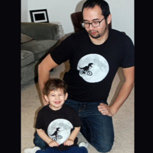 Camiseta Dinosaurio en bicicleta en cielo con luna