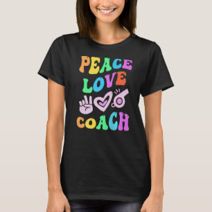 Camiseta El entrenador retro Groovy de PEACE LOVE COACH de 
