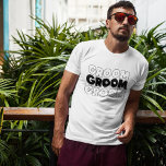 Camiseta El GROOM (nombre)<br><div class="desc">Al novio le encantará esta camiseta cuando se prepare para su gran día. El texto dice el GROOM. El mismo texto y color se repite en la parte posterior de esta camiseta. El texto es una imagen para que el color pueda cambiarse a cualquiera que elija.</div>