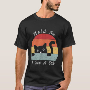 Camiseta Espera, veo una mirada de gato, juguetón y humorís