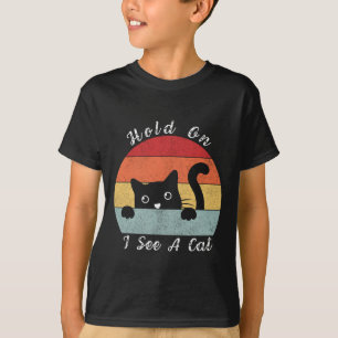 Camiseta Espera, veo una mirada de gato, juguetón y humorís