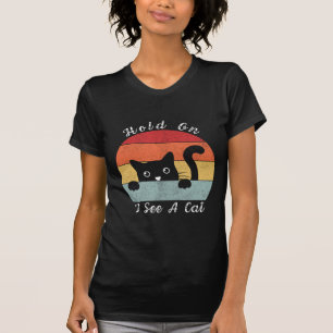 Camiseta Espera, veo una mirada de gato, juguetón y humorís