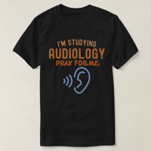 Camiseta Estoy estudiando audiología. Reza por mí