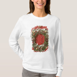 Camiseta Guirnalda del navidad que cuelga en una puerta