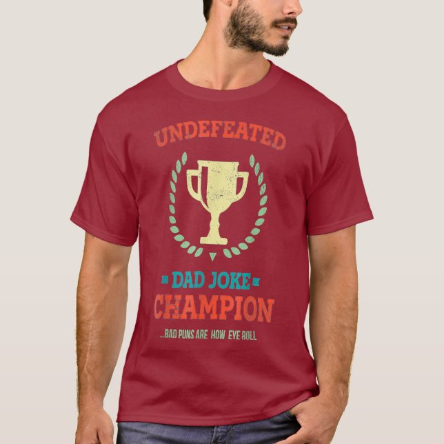 Camiseta Invencible Día de los Malos Puns, campeón del Chis (Anverso)