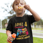 Camiseta Level 4 Unlocked - Funny Birthday 4 Kids<br><div class="desc">Celebrate your child's 4th birthday with this gamer-themed design for kids' birthdays. Featuring the phrase "LEVEL 4 UNLOCKED AWESOME SINCE CUSTOMIZABLE YEAR" in modern orange and red typography and a gamer controller in the background. The design is personalized with your child's year of birth, perfect for giving as a gift...</div>
