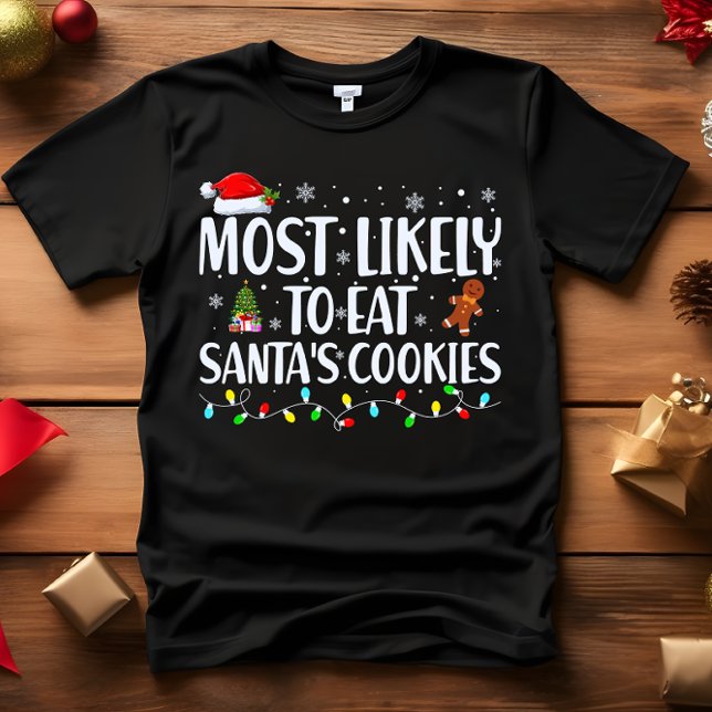 Camiseta Lo más probable es que coman a todos los NAVIDADES (FUNNY CHRISTMAS MOST LIKELY TO EAT SANTA'S COOKES CHRISTMAS TREE GINGERMAN AND LIGHTS)