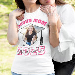 Camiseta Madre orgullosa rosa de una foto de graduado<br><div class="desc">¡Muéstrate lo orgulloso que estás de tu graduación con esta orgullosa madre de una camiseta graduada con letras rosas,  una foto de tu hijo o hija en un marco fotográfico con forma de gorra de graduación y el año en que se están graduando!</div>