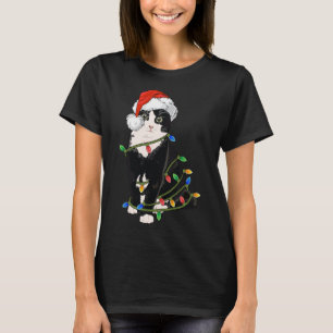 Camiseta Navidades de gatos negros iluminan regalo de Navid