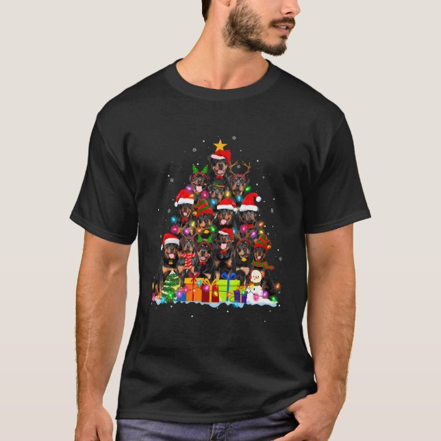 Camiseta Navidades de perro de Rottweiler iluminan a un per (Anverso)
