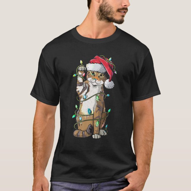 Camiseta Navidades Gorras del gato Santa Claus alumbran a c (Anverso)
