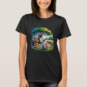 Camiseta Niña leyendo bajo un árbol rodeada de flores