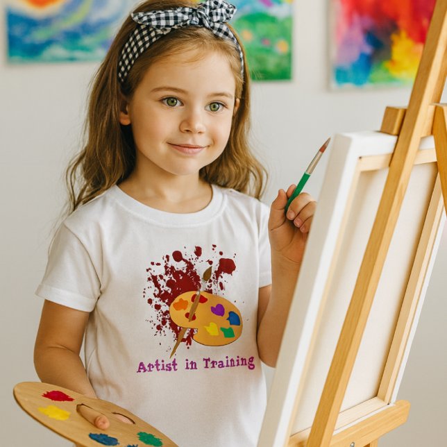 Camiseta Paint Splash Girls (Artist in Training” youth tee with vibrant palette graphic perfect for creative young painters)