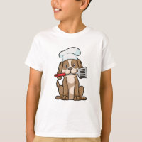 Perro cocinado con el gorra y la espátula del chef