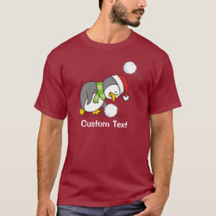Camiseta Pingüino navidad recibiendo bola de nieve