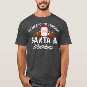 Camiseta Sé Agradable Con El Profesor Santa Está Viendo La