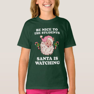 Camiseta Sé Agradable Con Los Estudiantes Que Santa Está Vi