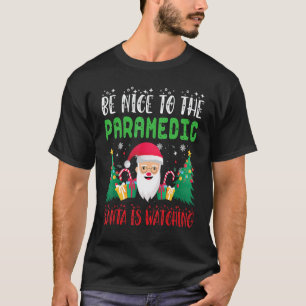 Camiseta Sé amable con el paramédico Santa está vigilando l