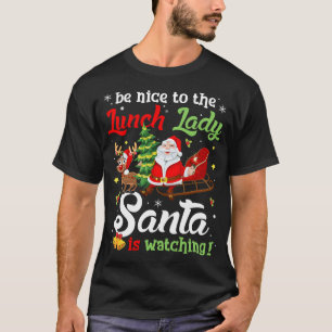 Camiseta Sé Amable Con La Señora Del Almuerzo Santa Está Mi