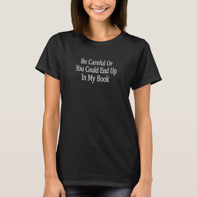 Camiseta Ten Cuidado O Podrías Terminar En Mi Libro (Anverso)