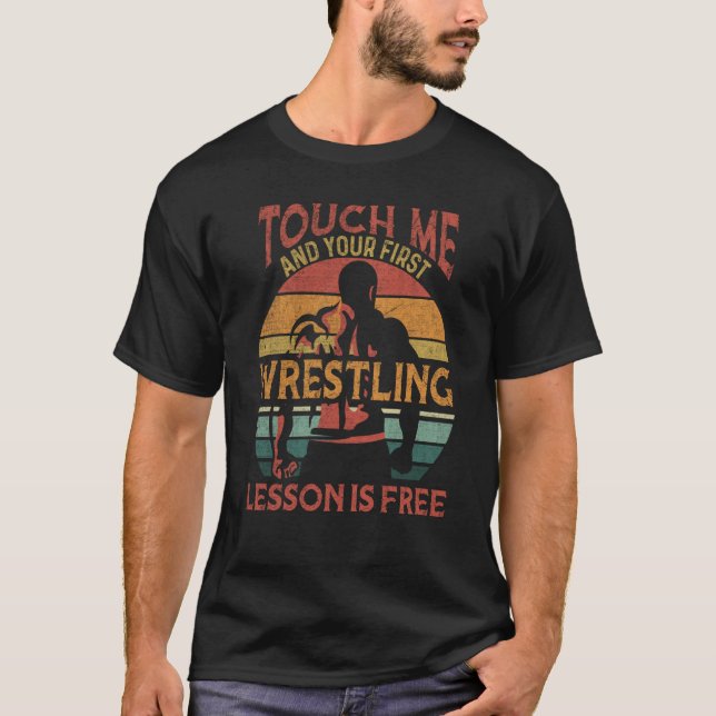 Camiseta Tócame y tu primera lección de lucha libre es grat (Anverso)