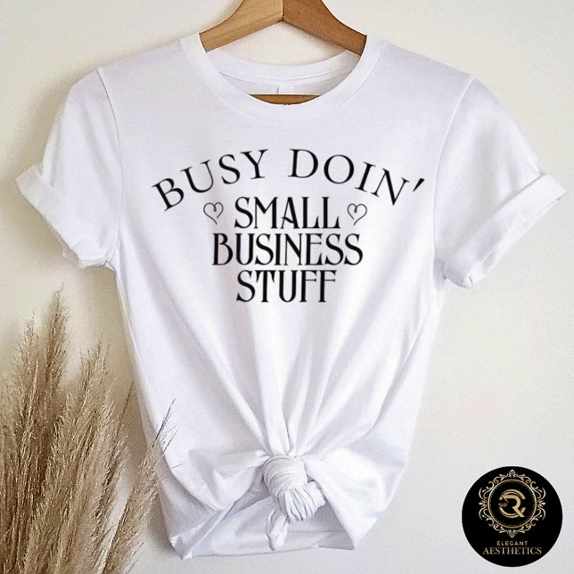 Camiseta Triblenda Business Casual Graphic Tee Doin' Business Stuff  (White t-shirt on hanger with quote "Busy Doin' Small Business Stuff")