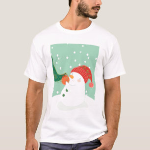 Camiseta Un muñeco de nieve que cuelga un ornamento en un