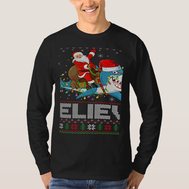 Camiseta Xmas Lights Shark Believe Ugly Santa Riding Shark  (Anverso)