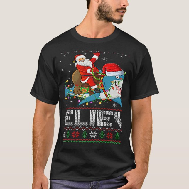 Camiseta Xmas Lights Shark Believe Ugly Santa Riding Shark  (Anverso)