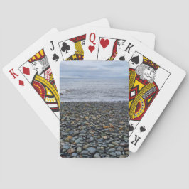 Cartas de juego en la playa de guijarros