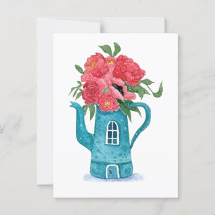 Casa azul de tetera con tarjeta de flores rojas