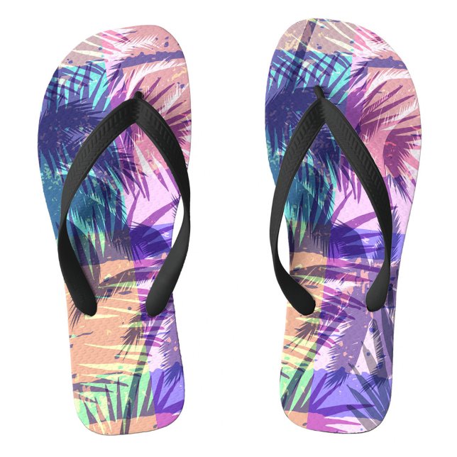 Chanclas Exótico (A palm leaf patterns in vivid colors. The background reveals gentle waves lapping at the shore.  )