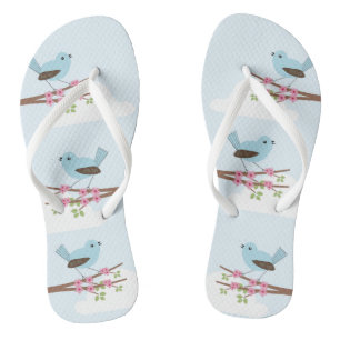 Chanclas Pájaro azul en cuchara de árbol floreciente